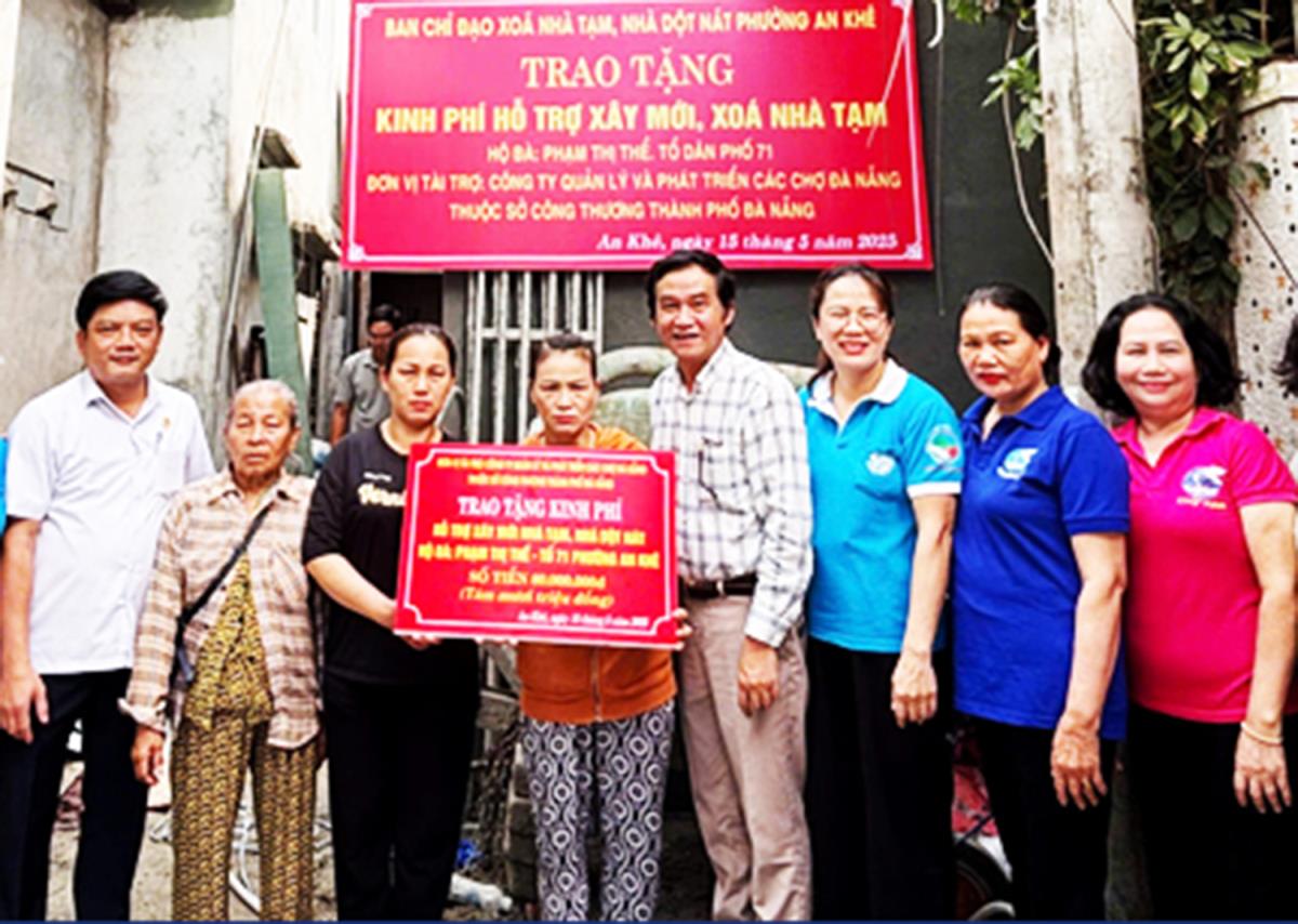 Đại diện lãnh đạo Công ty Quản lý và Phát triển các chợ Đà Nẵng trao tiền ủng hộ hộ bà Phạm Thị Thể xóa nhà tạm.