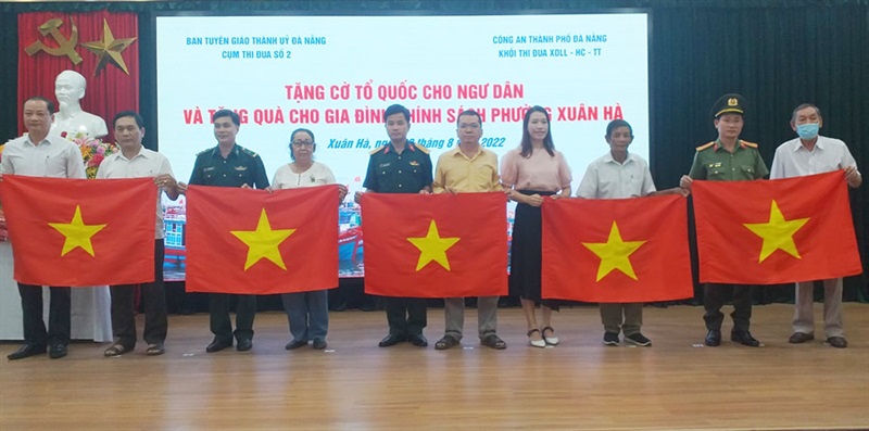 Đại diện các đơn vị Cụm thi đua số 2 trao tặng cờ Tổ quốc cho ngư dân P.Xuân Hà.