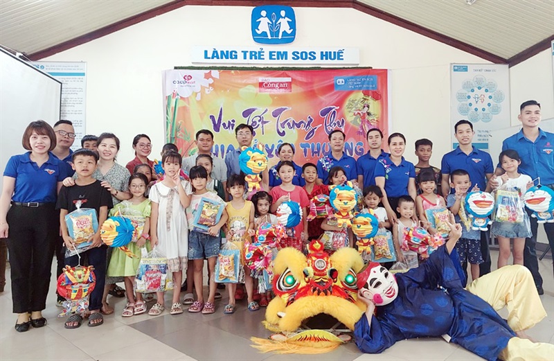 Đại diện Chuyên đề Công an TP Đà Nẵng cùng lãnh đạo Siêu thị Co.opmart Huế trao quà cho các trẻ em Làng SOS Huế.