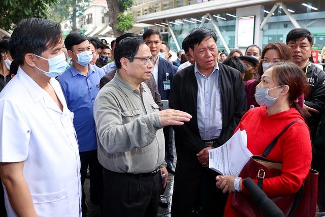 Thủ tướng thăm hỏi người nhà bệnh nhân về tình hình đáp ứng vật tư y tế và thuốc men tại bệnh viện Bạch Mai.